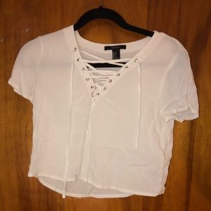 white crop top with cross string on the front